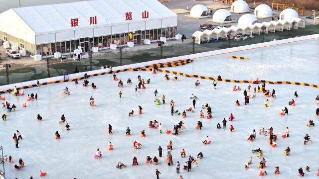 (260118) -- YINCHUAN, Jan. 18, 2026 (Xinhua) -- An aerial drone photo shows people having fun on an ice rink at a park in Yinchuan, northwest China's Ningxia Hui Autonomous Region, Jan. 17, 2026. (Xinhua/Wang Peng)