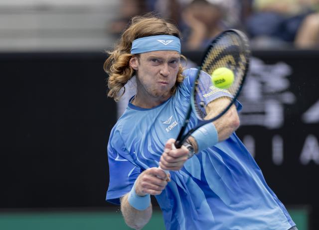 (260119) -- MELBOURNE, Jan. 19, 2026 (Xinhua) -- Andrey Rublev of Russia hits a return during the men's singles 1st round match against Matteo Arnaldi of Italy at the Australian Open tennis tournament in Melbourne, Australia, Jan. 19, 2026. (Photo by Hu Jingchen/Xinhua)