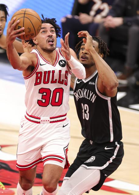 (260119) -- CHICAGO, Jan. 19, 2026 (Xinhua) -- Chicago Bulls' Tre Jones (L) drives to the basket during the 2025-2026 NBA regular season basketball game between Brooklyn Nets and Chicago Bulls at United Center in Chicago, the United States, Jan. 18, 2026. (Photo by Joel Lerner/Xinhua)