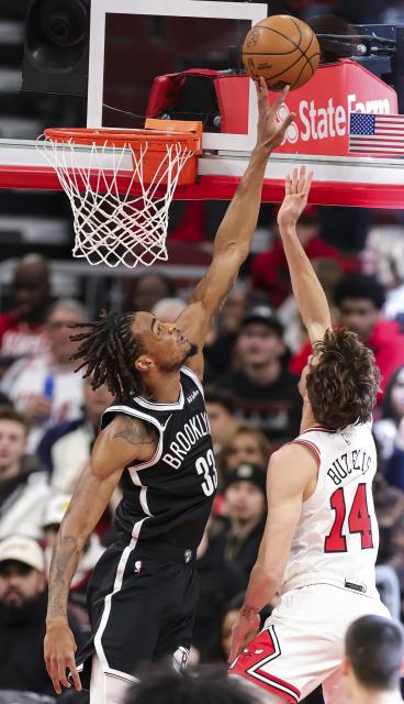 (260119) -- CHICAGO, Jan. 19, 2026 (Xinhua) -- Brooklyn Nets' Nic Claxton (L) blocks the shot of Chicago Bulls' Matas Buzelis during the 2025-2026 NBA regular season basketball game between Brooklyn Nets and Chicago Bulls at United Center in Chicago, the United States, Jan. 18, 2026. (Photo by Joel Lerner/Xinhua)
