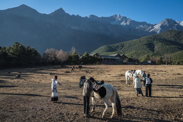(260119) -- LIJIANG, Jan. 19, 2026 (Xinhua) -- People visit a horse farm in Yuhu Village, Lijiang City, southwest China's Yunnan Province, Jan. 17, 2026. Yuhu Village, nestled in Baisha Township of Yulong Naxi Autonomous County in the city of Lijiang in Yunnan, is one of the earliest settlements of the Naxi ethnic people. The village was once among the poorest villages in Lijiang because of its poor soil and limited transportation links.   
  In recent years, Yuhu has developed a distinct path that balances economic growth with environmental protection. Leveraging its well-preserved Naxi cultural heritage and exceptional natural scenery, the village has attracted visitors from around the world. At the same time, it has continued to improve infrastructure and public services, attracting a growing number of residents to return home for businesses.  
  In 2025, Yuhu Village welcomed about 1.2 million visits, generating 75 million yuan (10.8 million U.S. dollars) in revenue -- with the average income of locals increasing from 13,000 yuan (1,865 U.S. dollars) in 2019 to about 35,000 yuan (5,022 U.S. dollars). (Xinhua/Wang Guansen)