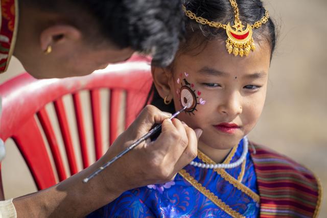 (260119) -- KATHMANDU, Jan. 19, 2026 (Xinhua) -- A girl in traditional attire from the Tamang community gets face painting during a celebration of the Sonam Lhosar festival in Kathmandu, Nepal, Jan. 19, 2026. Sonam Lhosar is observed as the lunar new year by the Tamang community, an ethnic indigenous group living in Nepal. (Photo by Hari Maharjan/Xinhua)