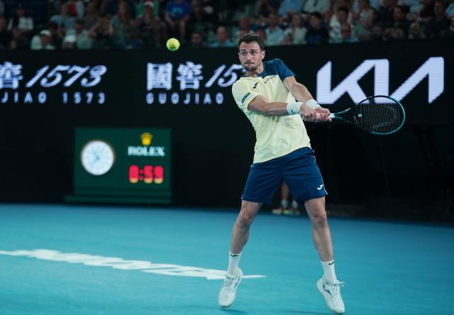 (260119) -- MELBOURNE, Jan. 19, 2026 (Xinhua) -- Pedro Martinez hits a return during the men's singles 1st round match between Pedro Martinez of Spain and Novak Djokovic of Serbia at the Australian Open tennis tournament in Melbourne, Australia, Jan. 19, 2026. (Photo by Wang Shen/Xinhua)