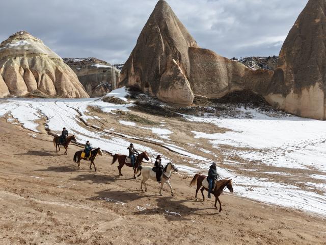(260119) -- CAPPADOCIA, Jan. 19, 2026 (Xinhua) -- Tourists ride horses among the unique fairy chimneys rocks in Cappadocia, Türkiye, Jan. 16, 2026. (Photo by Mustafa Kaya/Xinhua)