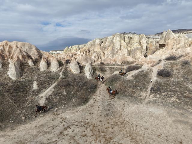 (260119) -- CAPPADOCIA, Jan. 19, 2026 (Xinhua) -- Tourists ride horses among the unique fairy chimneys rocks in Cappadocia, Türkiye, Jan. 16, 2026. (Photo by Mustafa Kaya/Xinhua)