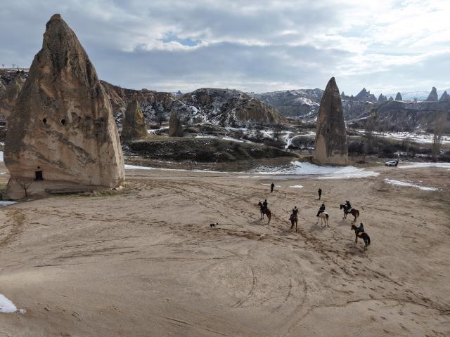 (260119) -- CAPPADOCIA, Jan. 19, 2026 (Xinhua) -- Tourists ride horses among the unique fairy chimneys rocks in Cappadocia, Türkiye, Jan. 16, 2026. (Photo by Mustafa Kaya/Xinhua)
