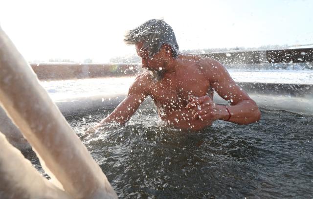(260119) -- MINSK, Jan. 19, 2026 (Xinhua) -- A man takes a dip in the icy water during the Orthodox Epiphany celebrations in Minsk, Belarus, Jan. 19, 2026. (Photo by Henadz Zhinkov/Xinhua)