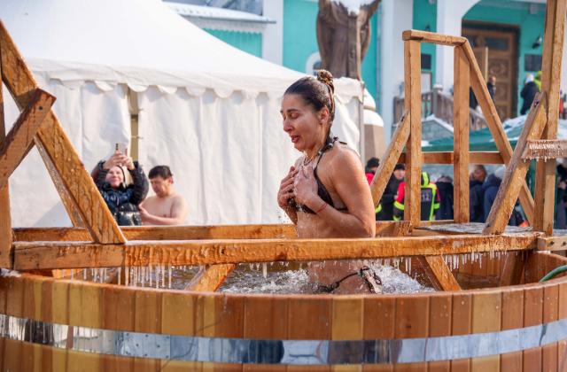 (260119) -- ALMATY, Jan. 19, 2026 (Xinhua) -- A woman bathes in the icy water during the Orthodox Epiphany celebrations in Almaty, Kazakhstan, Jan. 19, 2026. (Str/Xinhua)