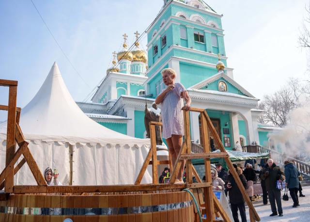 (260119) -- ALMATY, Jan. 19, 2026 (Xinhua) -- A woman prepares to bath in the icy water during the Orthodox Epiphany celebrations in Almaty, Kazakhstan, Jan. 19, 2026. (Str/Xinhua)