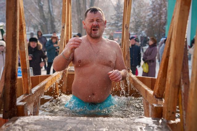 (260119) -- ALMATY, Jan. 19, 2026 (Xinhua) -- A man bathes in the icy water during the Orthodox Epiphany celebrations in Almaty, Kazakhstan, Jan. 19, 2026. (Str/Xinhua)
