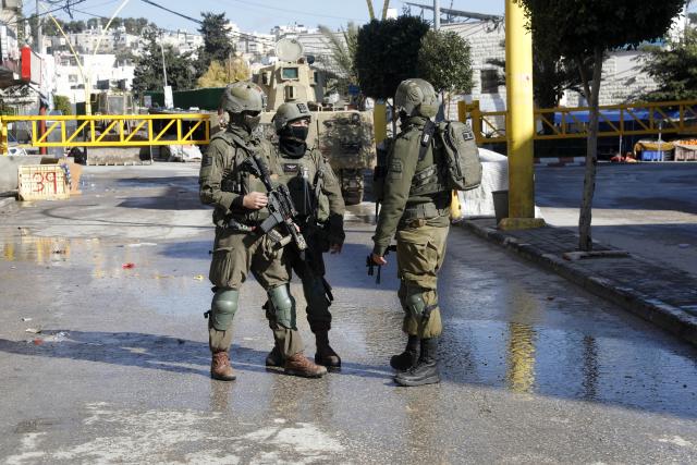 (260119) -- HEBRON, Jan. 19, 2026 (Xinhua) -- Members of Israeli forces are seen as they impose a closure around the Jabal Johar neighborhood south of Hebron city in the West Bank, on Jan. 19, 2026. The Israeli army has launched a large-scale military operation in the city of Hebron in the southern West Bank, Palestinian and Israeli sources said Monday. (Photo by Mamoun Wazwaz/Xinhua)