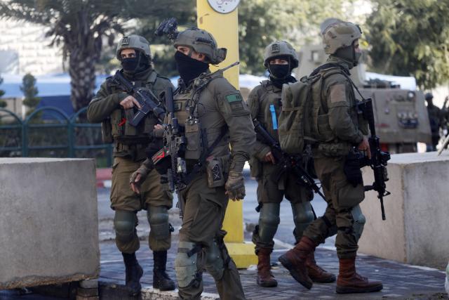 (260119) -- HEBRON, Jan. 19, 2026 (Xinhua) -- Members of Israeli forces are seen as they impose a closure around the Jabal Johar neighborhood south of Hebron city in the West Bank, on Jan. 19, 2026. The Israeli army has launched a large-scale military operation in the city of Hebron in the southern West Bank, Palestinian and Israeli sources said Monday. (Photo by Mamoun Wazwaz/Xinhua)