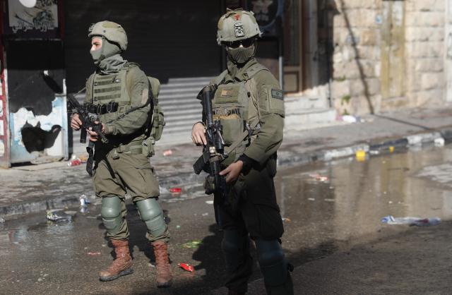 (260119) -- HEBRON, Jan. 19, 2026 (Xinhua) -- Members of Israeli forces are seen as they impose a closure around the Jabal Johar neighborhood south of Hebron city in the West Bank, on Jan. 19, 2026. The Israeli army has launched a large-scale military operation in the city of Hebron in the southern West Bank, Palestinian and Israeli sources said Monday. (Photo by Mamoun Wazwaz/Xinhua)