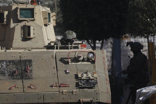 (260119) -- HEBRON, Jan. 19, 2026 (Xinhua) -- Members of Israeli forces are seen as they impose a closure around the Jabal Johar neighborhood south of Hebron city in the West Bank, on Jan. 19, 2026. The Israeli army has launched a large-scale military operation in the city of Hebron in the southern West Bank, Palestinian and Israeli sources said Monday. (Photo by Mamoun Wazwaz/Xinhua)