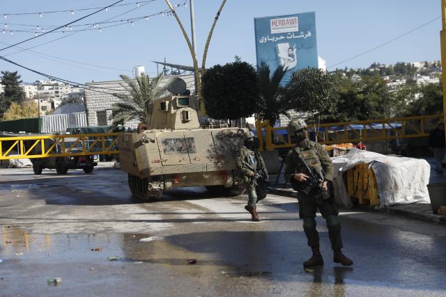 (260119) -- HEBRON, Jan. 19, 2026 (Xinhua) -- Members of Israeli forces are seen as they impose a closure around the Jabal Johar neighborhood south of Hebron city in the West Bank, on Jan. 19, 2026. The Israeli army has launched a large-scale military operation in the city of Hebron in the southern West Bank, Palestinian and Israeli sources said Monday. (Photo by Mamoun Wazwaz/Xinhua)