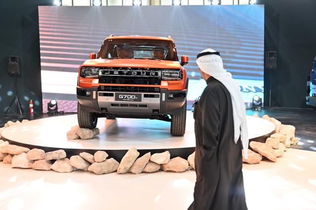 (260119) -- HAWALLI GOVERNORATE, Jan. 19, 2026 (Xinhua) -- A man visits the booth of Chinese car brand Jetour G700 during the Auto Show in Hawalli Governorate, Kuwait, Jan. 19, 2026. The Auto Show kicked off in Kuwait's Hawalli Governorate on Monday with the participation of more than 120 cars from around 30 car dealers showing 40 car brands. The event will last for 6 days from Jan. 19 to 24. (Photo by Asad/Xinhua)