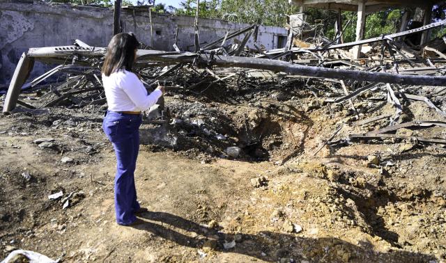 (260119) -- MIRANDA STATE(VENEZUELA), Jan. 19, 2026 (Xinhua) -- A staff member of the Venezuelan Institute for Scientific Research inspects blast craters in Miranda State, Venezuela, Jan. 19, 2026. As Venezuela's premier hub for scientific research and talent cultivation, The Venezuelan Institute for Scientific Research suffered significant damage during the U.S. attack on Venezuela which caused damage to buildings and precision scientific equipment in the early hours of January 3. (Xinhua/Ding Hongfa)