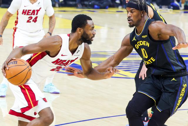 (260120) -- SAN FRANCISCO, Jan. 20, 2026 (Xinhua) -- Golden State Warriors' Jimmy Butler III (R) defends Miami Heat's Andrew Wiggins during the 2025-2026 NBA regular season basketball game between Golden State Warriors and Miami Heat in San Francisco, the United States, Jan. 19, 2026. (Photo by Arthur Dong/Xinhua)