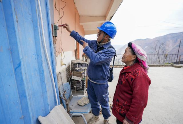 (260120) -- ZHAOTONG, Jan. 20, 2026 (Xinhua) -- An electricity worker checks a power switch for a villager in Hongshiyan Village of Qiaojia County, southwest China's Yunnan Province, Jan. 20, 2026. A 5.1-magnitude earthquake jolted Qiaojia County in southwest China's Yunnan Province on Monday evening, prompting local authorities to evacuate dozens of residents, though no casualties or building collapses were reported. The China Earthquake Administration has activated a Level-III emergency response to the earthquake in Yunnan and dispatched working teams to the affected area to support local relief efforts. (Xinhua/Chen Xinbo)