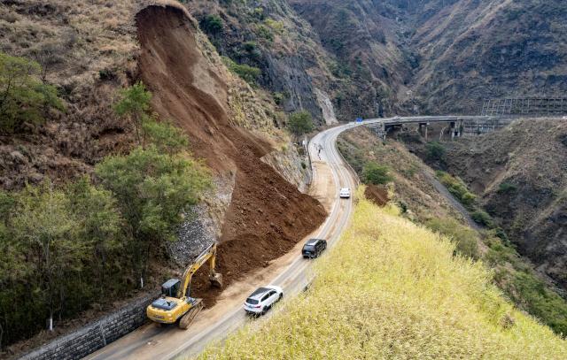 (260120) -- ZHAOTONG, Jan. 20, 2026 (Xinhua) -- An aerial drone photo shows an excavator clearing a section of a road after an earthquake in Qiaojia County in southwest China's Yunnan Province, Jan. 20, 2026. A 5.1-magnitude earthquake jolted Qiaojia County in southwest China's Yunnan Province on Monday evening, prompting local authorities to evacuate dozens of residents, though no casualties or building collapses were reported. The China Earthquake Administration has activated a Level-III emergency response to the earthquake in Yunnan and dispatched working teams to the affected area to support local relief efforts. (Xinhua/Chen Xinbo)