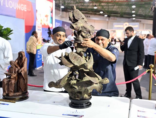 (260120) -- HAWALLI GOVERNORATE, Jan. 20, 2026 (Xinhua) -- Staff members work at a booth during the HORECA Kuwait 2026 exhibition in Hawalli Governorate, Kuwait, Jan. 19, 2026. The exhibition was launched here on Monday and will continue until Jan. 21.  HORECA is a combination of the words HO (hotels), RE (restaurants) and CA (cafes). (Photo by Asad/Xinhua)