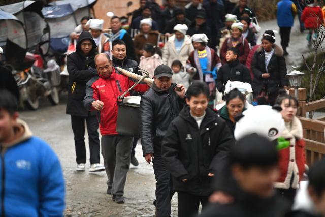 (260120) -- LIUZHOU, Jan. 20, 2026 (Xinhua) -- Villagers are on their way to attend a banquet during traditional Miao New Year celebrations at Dangjiu Village in Gandong Township of Rongshui Miao Autonomous County, south China's Guangxi Zhuang Autonomous Region, Jan. 20, 2026, also the Great Cold (Dahan) solar term on the Chinese lunar calendar. Miao New Year is a major festival of people of Miao ethnic group. In 2008, the festival was listed as a national-level intangible cultural heritage. (Xinhua/Huang Xiaobang)