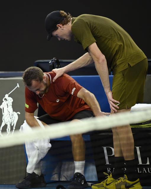 (260120) -- MELBOURNE, Jan. 20, 2026 (Xinhua) -- Jannik Sinner (R) comforts Hugo Gaston during the men's singles 1st round match between Hugo Gaston of France and Jannik Sinner of Italy at the Australian Open tennis tournament in Melbourne, Australia, Jan. 20, 2026. (Photo by Wang Shen/Xinhua)
