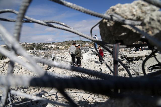 (260120) -- HEBRON, Jan. 20, 2026 (Xinhua) -- Palestinians inspect a destroyed house after the Israeli forces demolished it, in the West Bank city of Hebron, Jan. 20, 2026. (Photo by Mamoun Wazwaz/Xinhua)