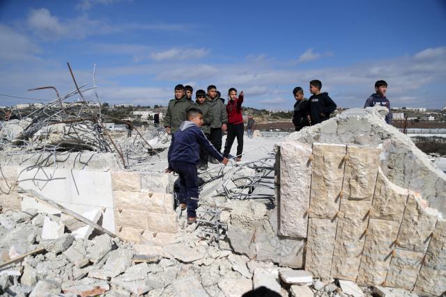 (260120) -- HEBRON, Jan. 20, 2026 (Xinhua) -- Palestinian boys inspect a destroyed house after the Israeli forces demolished it, in the West Bank city of Hebron, Jan. 20, 2026. (Photo by Mamoun Wazwaz/Xinhua)