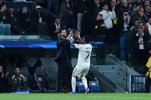 (260121) -- MADRID, Jan. 21, 2026(Xinhua) -- Real Madrid's Vinicius Junior (R) celebrates his goal with head coach Alvaro Arbeloa during the UEFA Champions League match between Real Madrid and AS Monaco, Madrid, Spain, Jan. 20, 2026. (Photo by Gustavo Valiente/Xinhua)