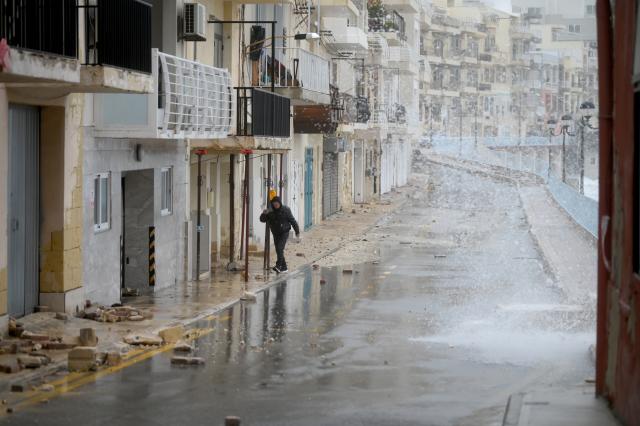 (260121) --  MARSASCALA, Jan. 21, 2026 (Xinhua) -- A pedestrian walks on a street affected by Storm Harry in Marsascala, eastern Malta, Jan. 20, 2026. The coast of Malta was hit by strong winds and high waves as Storm Harry battered its islands. (Photo by Jonathan Borg/Xinhua)