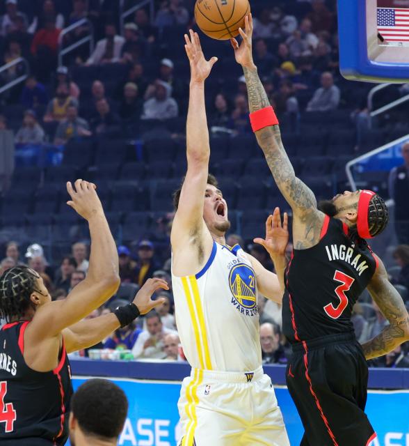 (260121) -- SAN FRANCISCO, Jan. 21, 2026 (Xinhua) -- Golden State Warriors' Quinten Post (C) shoots against Toronto Raptors' Brandon Ingram (R) during the 2025-2026 NBA regular season basketball game between Golden State Warriors and Toronto Raptors in San Francisco, the United States, Jan. 20, 2026. (Photo by Arthur Dong/Xinhua)