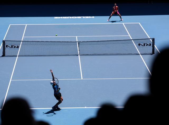 (260121) -- MELBOURNE, Jan. 21, 2026 (Xinhua) -- Bai Zhuoxuan (front) of China serves during the women's singles 2nd round match against Aryna Sabalenka of Belarus at the Australian Open tennis tournament in Melbourne, Australia, Jan. 21, 2026. (Xinhua/Ma Ping)