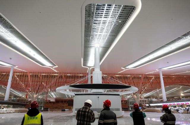 (260121) -- XIAMEN, Jan. 21, 2026 (Xinhua) -- Workers check lighting conditions during an inspection of the power supply systems at the Xiamen Xiang'an International Airport in Xiamen, southeast China's Fujian Province, Jan. 20, 2026. Construction of the Xiamen Xiang'an International Airport has entered a critical phase involving completion acceptance, flight tests and calibrations, and relocation preparations. With its operation slated for late 2026, the airport will be able to handle 45 million passengers, 750,000 tonnes of cargo and mail, as well as 380,000 aircraft take-offs and landings on a yearly basis. (Xinhua/Wei Peiquan)