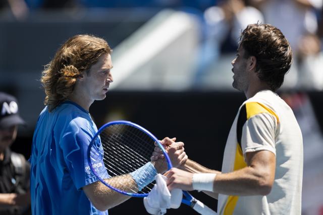 (260121) -- MELBOURNE, Jan. 21, 2026 (Xinhua) -- Andrey Rublev (L) of Russia and Jaime Faria of Portugal react during the men's singles 2nd round match between Andrey Rublev of Russia and Jaime Faria of Portugal at the Australian Open tennis tournament in Melbourne, Australia, Jan. 21, 2026 (Photo by Hu Jingchen/Xinhua)