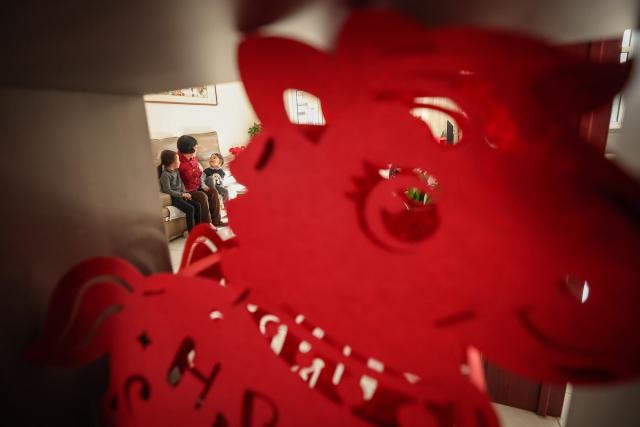 (260121) -- HULUDAO, Jan. 21, 2026 (Xinhua) -- A villager (C) is accompanied by her grandchildren at her home at Zhujiagou Village, Suizhong County, Huludao City, northeast China's Liaoning Province, Jan. 20, 2026. Huludao was severely affected by floods in August 2024, and the low-lying Zhujiagou Village of Suizhong County used to be among the hardest-hit rural areas in the city. The village has undergone a complete transformation thanks to swift post-disaster reconstruction efforts. (Xinhua/Pan Yulong)