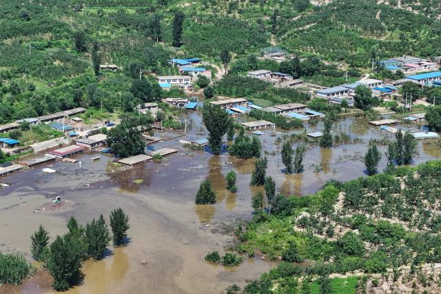 (260121) -- HULUDAO, Jan. 21, 2026 (Xinhua) -- An aerial drone photo shows a scene of flooding at Zhujiagou Village, Suizhong County, Huludao City, northeast China's Liaoning Province, Aug. 22, 2024. Huludao was severely affected by floods in August 2024, and the low-lying Zhujiagou Village of Suizhong County used to be among the hardest-hit rural areas in the city. The village has undergone a complete transformation thanks to swift post-disaster reconstruction efforts. (Photo by Yang Huan/Xinhua)