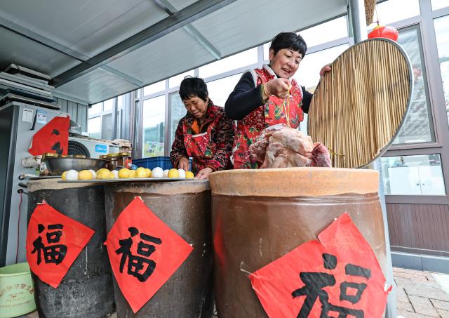 (260121) -- HULUDAO, Jan. 21, 2026 (Xinhua) -- Villagers prepare food for the Chinese New Year at Zhujiagou Village, Suizhong County, Huludao City, northeast China's Liaoning Province, Jan. 14, 2026. Huludao was severely affected by floods in August 2024, and the low-lying Zhujiagou Village of Suizhong County used to be among the hardest-hit rural areas in the city. The village has undergone a complete transformation thanks to swift post-disaster reconstruction efforts. (Photo by Tian Jia/Xinhua)