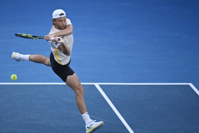(260121) -- MELBOURNE, Jan. 21, 2026 (Xinhua) -- Alexandre Muller hits a return during the men's singles 2nd round match between Alexander Zverev of Germany and Alexandre Muller of France at the Australian Open tennis tournament in Melbourne, Australia, Jan. 21, 2026. (Photo by Wang Shen/Xinhua)