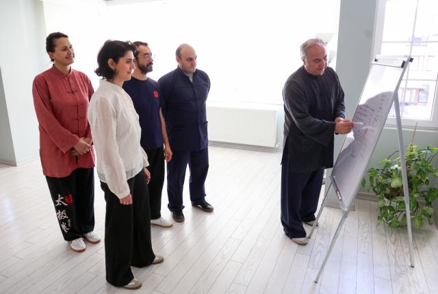 (260121) -- ANKARA, Jan. 21, 2026 (Xinhua) -- Numan Pekgoz (1st R), a Turkish Tai Chi master, instructs students at a studio in Ankara, Türkiye, Jan. 17, 2026. TO GO WITH "Interview: Turks turn to Tai Chi to ease stress of city life, says master" (Photo by Mustafa Kaya/Xinhua)