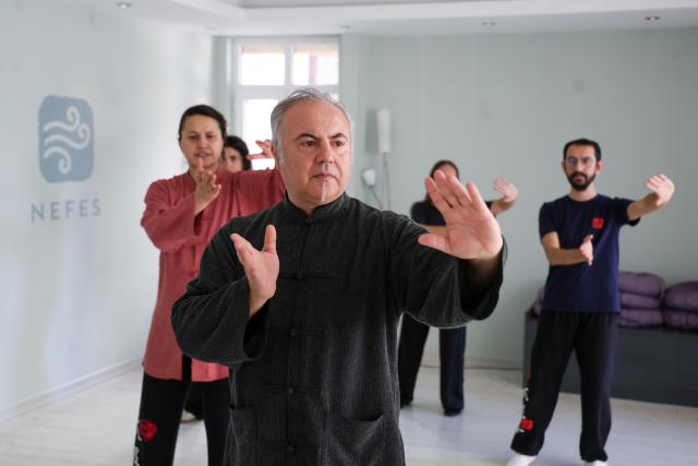 (260121) -- ANKARA, Jan. 21, 2026 (Xinhua) -- Numan Pekgoz (front), a Turkish Tai Chi master, demonstrates Tai Chi to students at a studio in Ankara, Türkiye, Jan. 17, 2026. TO GO WITH "Interview: Turks turn to Tai Chi to ease stress of city life, says master" (Photo by Mustafa Kaya/Xinhua)