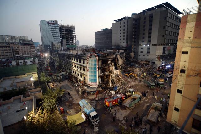(260121) -- KARACHI, Jan. 21, 2026 (Xinhua) -- Rescuers work at the fire site of a shopping mall in southern Pakistani port city of Karachi on Jan. 21, 2026. The death toll from a shopping mall fire in Pakistan's southern port city of Karachi climbed to 60 after at least 30 bodies were recovered from a shop of the multi-storey building, officials said on Wednesday. (Str/Xinhua)