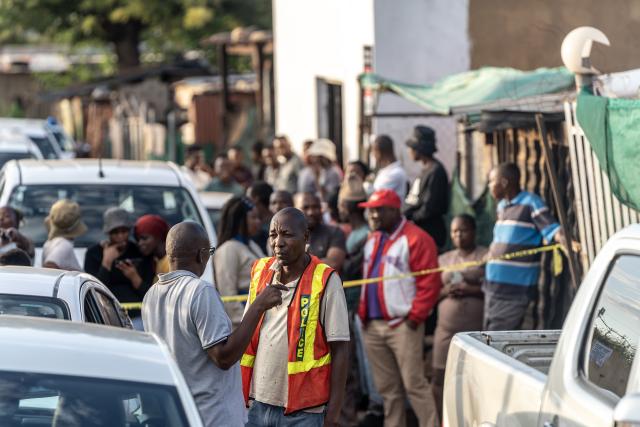 (260121) -- ATTERIDGEVILLE, Jan. 21, 2026 (Xinhua) -- People gather at the scene of a shooting incident in Jeffsville, Atteridgeville, Gauteng Province, South Africa, Jan. 21, 2026. Five people were shot dead on Wednesday outside a tuck shop in Jeffsville, Atteridgeville, in South Africa's Gauteng Province, local police said in a statement. (Photo by Shiraaz Mohamed/Xinhua)