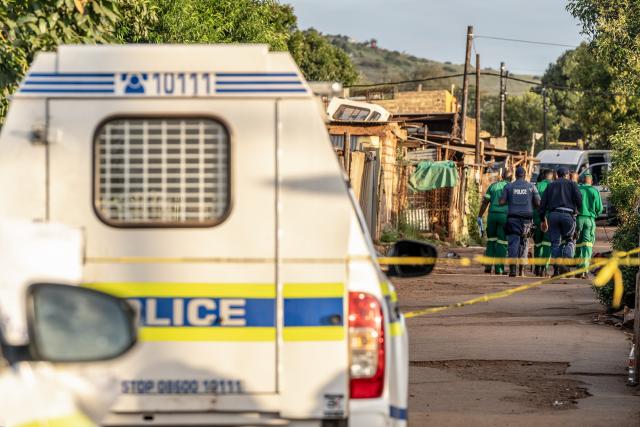 (260121) -- ATTERIDGEVILLE, Jan. 21, 2026 (Xinhua) -- Police officers cordon off the scene of a shooting incident in Jeffsville, Atteridgeville, Gauteng Province, South Africa, Jan. 21, 2026. Five people were shot dead on Wednesday outside a tuck shop in Jeffsville, Atteridgeville, in South Africa's Gauteng Province, local police said in a statement. (Photo by Shiraaz Mohamed/Xinhua)
