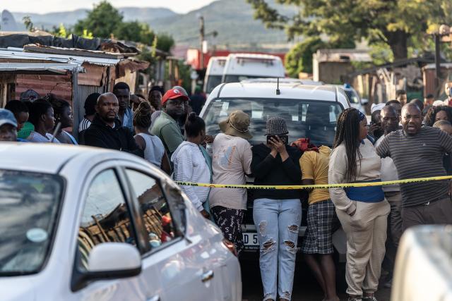 (260121) -- ATTERIDGEVILLE, Jan. 21, 2026 (Xinhua) -- People gather at the scene of a shooting incident in Jeffsville, Atteridgeville, Gauteng Province, South Africa, Jan. 21, 2026. Five people were shot dead on Wednesday outside a tuck shop in Jeffsville, Atteridgeville, in South Africa's Gauteng Province, local police said in a statement. (Photo by Shiraaz Mohamed/Xinhua)