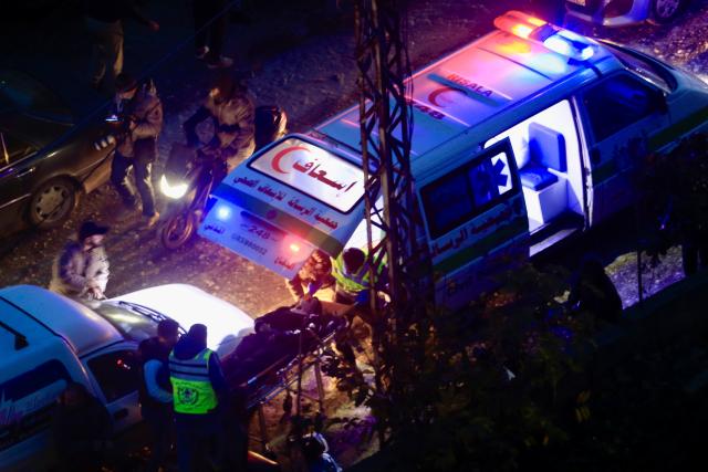 (260121) -- QENNARIT, Jan. 21, 2026 (Xinhua) -- Paramedics rescue one of the wounded after Israeli airstrikes in Qennarit, near Sidon, southern Lebanon, Jan. 21, 2026. Israeli airstrikes injured 19 people in southern Lebanon on Wednesday, including eight journalists, according to Lebanon's Ministry of Public Health. (Photo by Ali Hashisho/Xinhua)