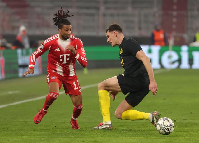 (260122) -- MUNICH, Jan. 22, 2026 (Xinhua) -- Michael Olise (L) of Bayern Munich vies with Ross Sykes of Union Saint-Gilloise during the UEFA Champions League match between Bayern Munich and Union Saint-Gilloise in Munich, Germany, Jan. 21, 2026. (Photo by Philippe Ruiz/Xinhua)