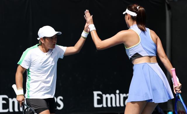 (260122) -- MELBOURNE, Jan. 22, 2026 (Xinhua) -- Jiang Xinyu (L)/Chan Hao-Ching react during the women's doubles 1st round match between Jiang Xinyu (China)/Chan Hao-Ching (Chinese Taipei) and Anna Blinkova (Russia)/Kamilla Rakhimova (Uzbekistan) at the Australian Open tennis tournament in Melbourne, Australia, Jan. 22, 2026. (Xinhua/Ma Ping)