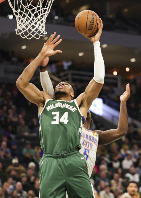 (260122) -- MILWAUKEE, Jan. 22, 2026 (Xinhua) -- Milwaukee Bucks' Giannis Antetokounmpo (front) drives to the basket during the 2025-2026 NBA regular season game between Milwaukee Bucks and Oklahoma City Thunder in Milwaukee, the United States, Jan. 21, 2026. (Photo by Joel Lerner/Xinhua)
