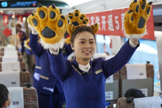 (260122) -- HARBIN, Jan. 22, 2026 (Xinhua) -- Train attendants perform on bullet train G902 from Harbin, northeast China's Heilongjiang Province, to Beijing, capital of China, on Jan. 22, 2026. The Beijing-Harbin high-speed railway marked the 5th anniversary of its full operation on Thursday. At 1,198 kilometers, the rail line links China's northeastern provinces of Liaoning, Jilin and Heilongjiang with the capital Beijing. (Xinhua/Wang Song)